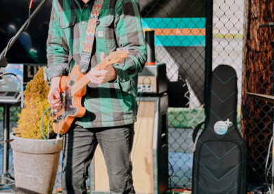 Musician performing live with an electric guitar during the 2025 Poulsbo Beer Run outdoor celebration.