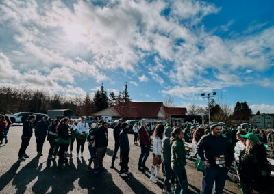 Participants gathering under blue skies before the start of the 2025 Poulsbo Beer Run in downtown Poulsbo.