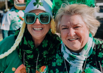 Two women dressed in green St. Patrick’s Day attire posing together at the 2025 Poulsbo Beer Run.