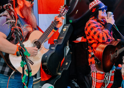 Two musicians performing acoustic guitars during the 2025 Poulsbo Beer Run celebration.