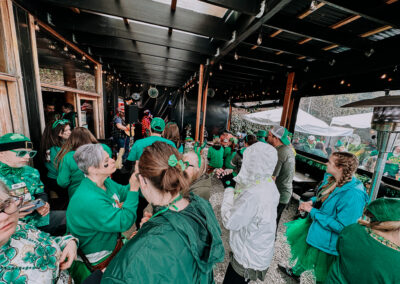 Participants socializing on a covered patio after the 2025 Poulsbo Beer Run event.