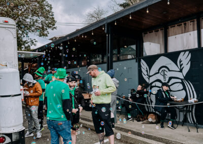 Soap bubbles floating above participants during the 2025 Poulsbo Beer Run celebration.